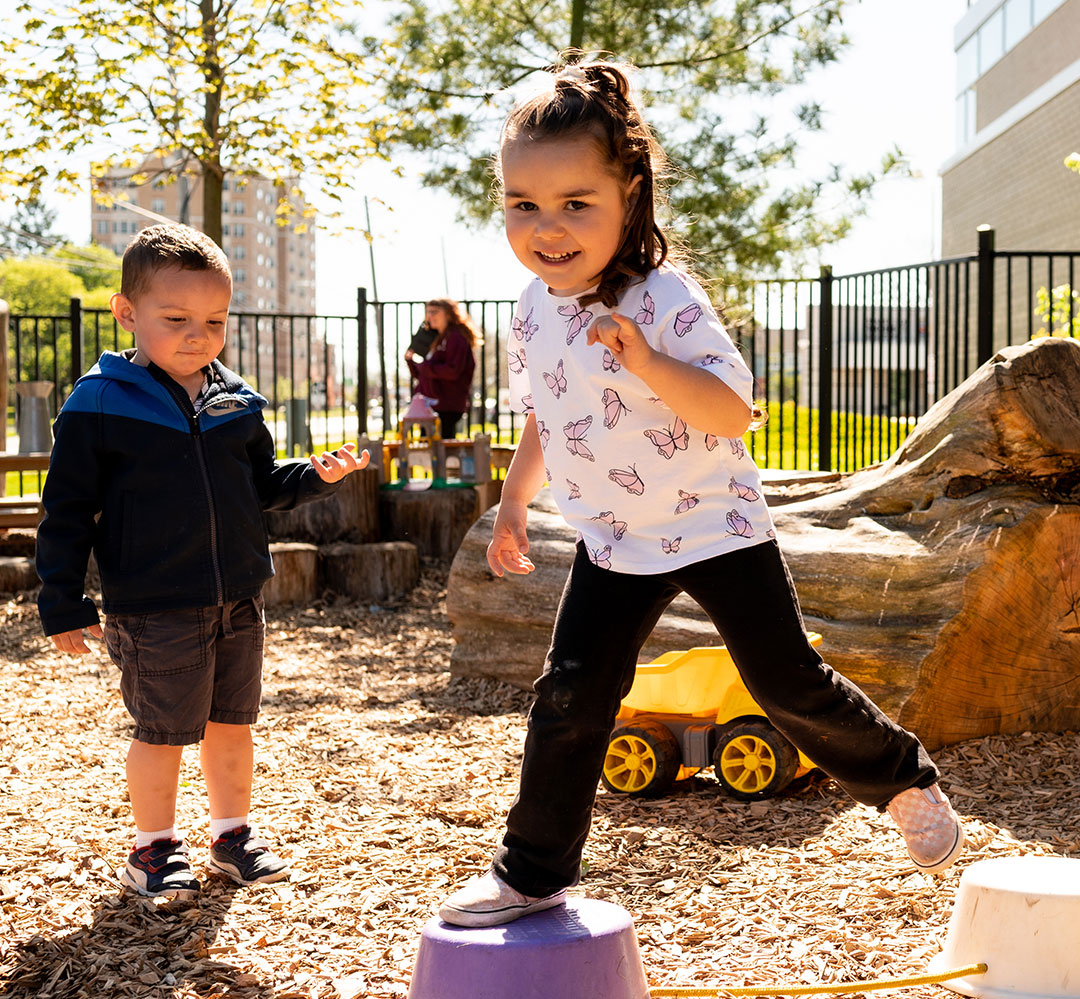 Future Child Care Centres (teaser) girl and boy playing in natural outdoor playground