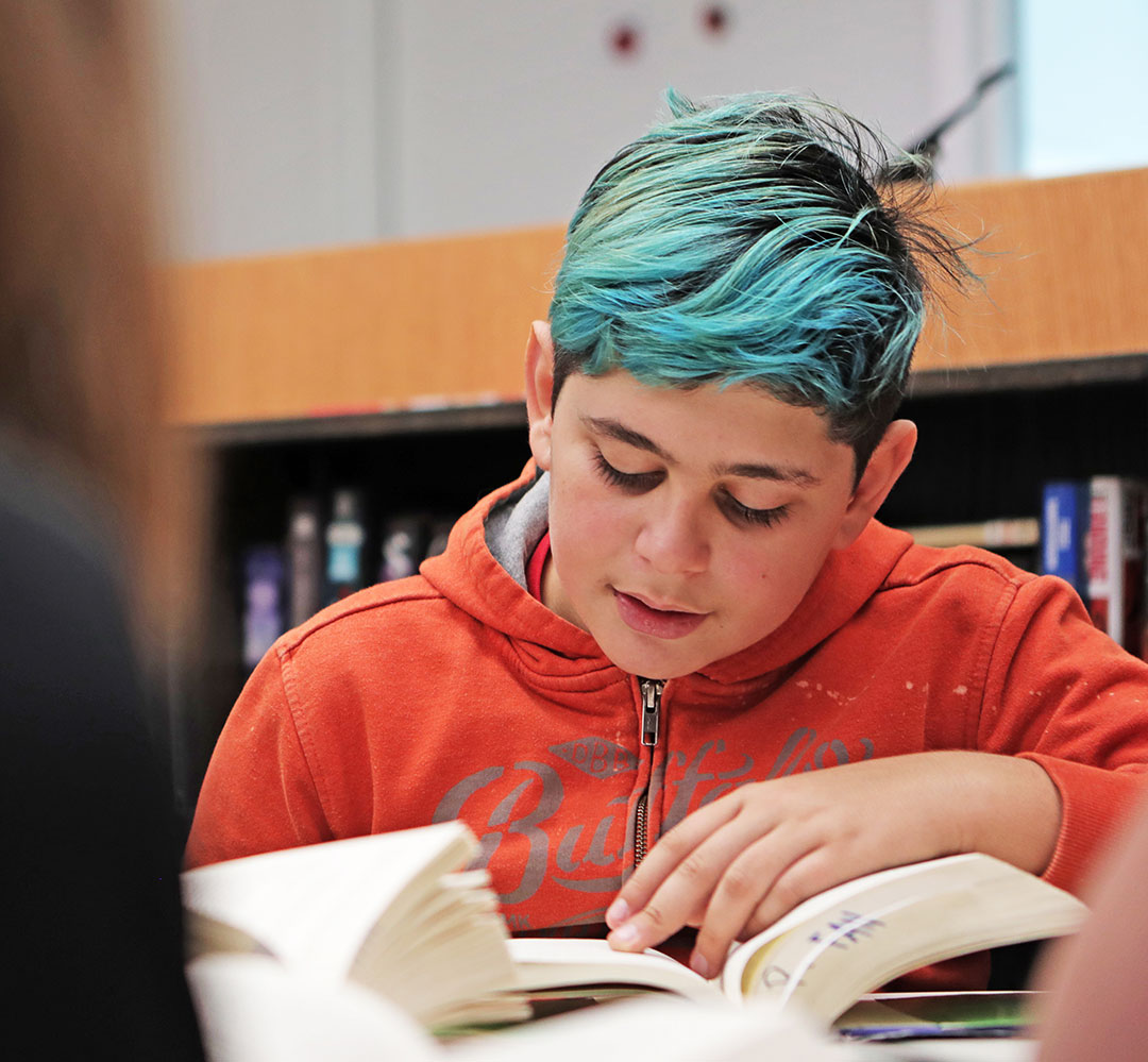 young person reading a book