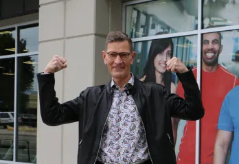 man in leather jacket flexing arms