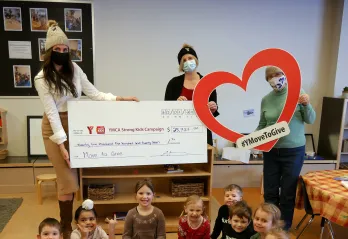 3 women holding up a cheque with children