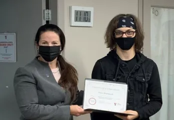 Two people holding up a certificate