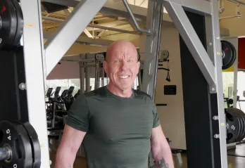 man in gym smiling