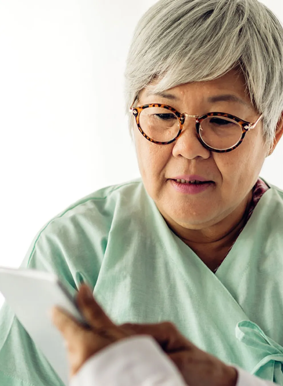 Doctor showing information to senior patient