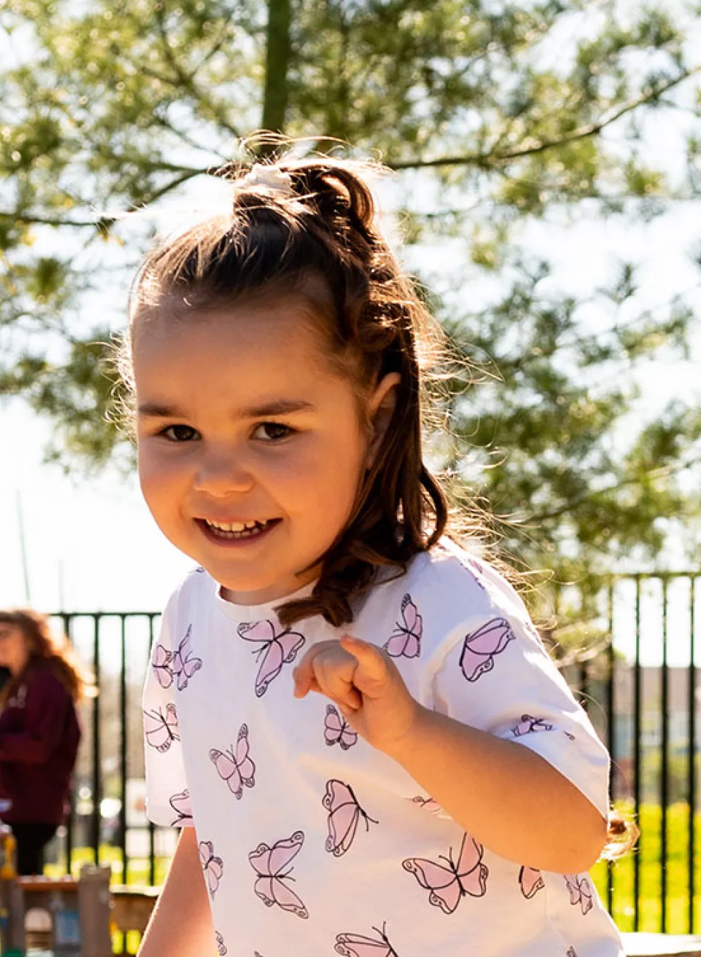 girl and boy playing in natural outdoor playground
