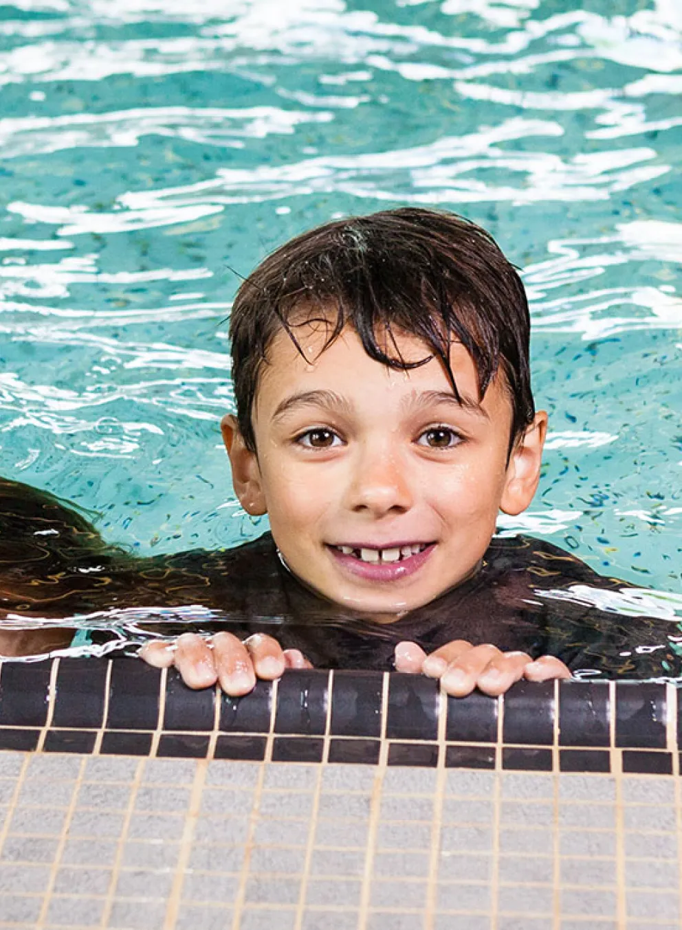 three happy children in a pool
