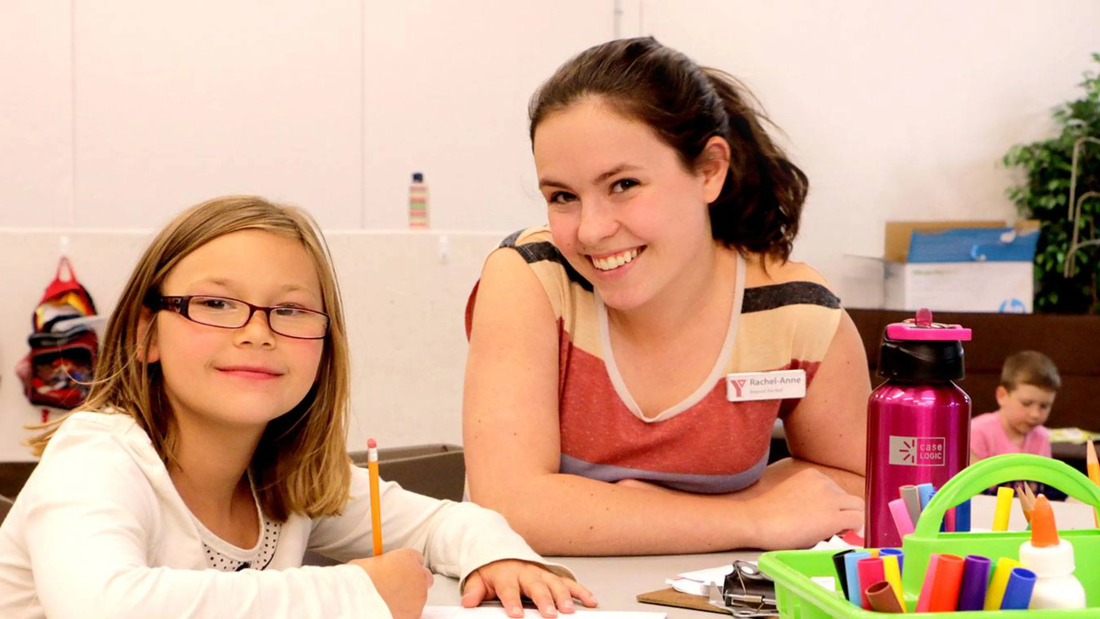girl getting help with her homework at YMCA Beyond the Bell