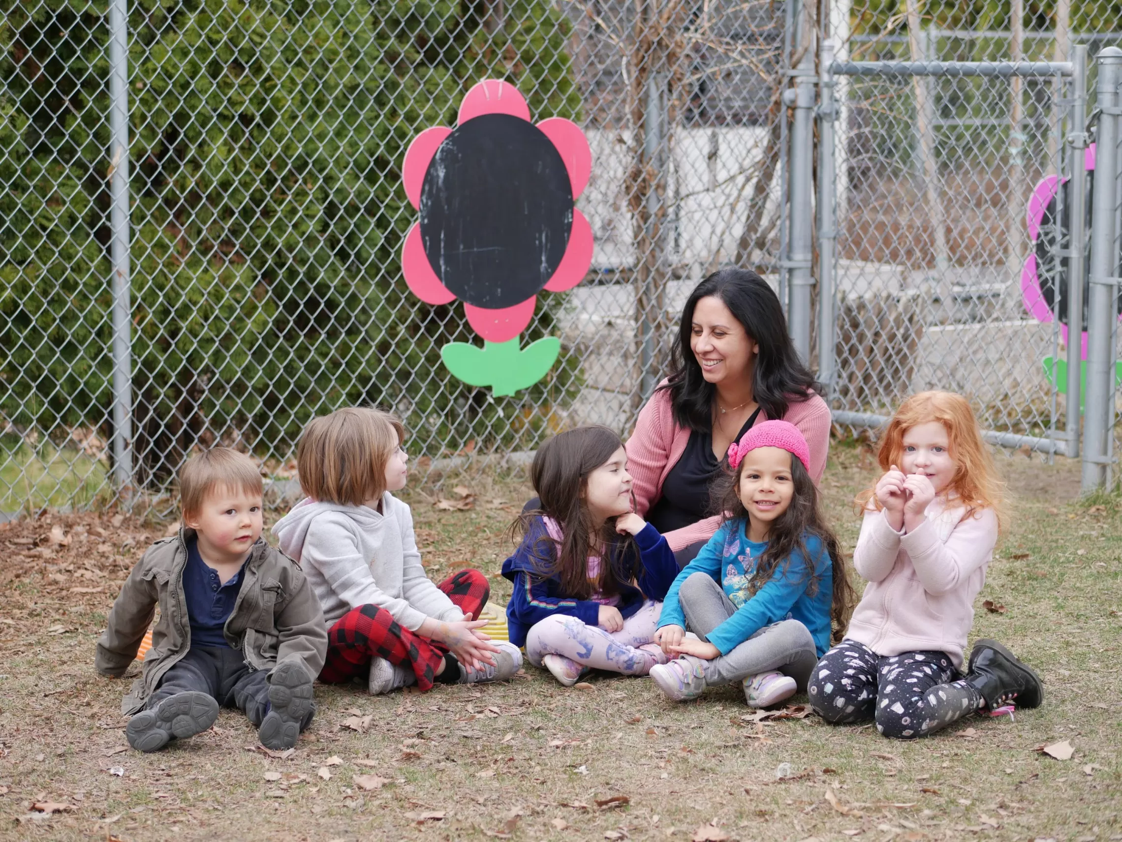 woman with kids sitting outside