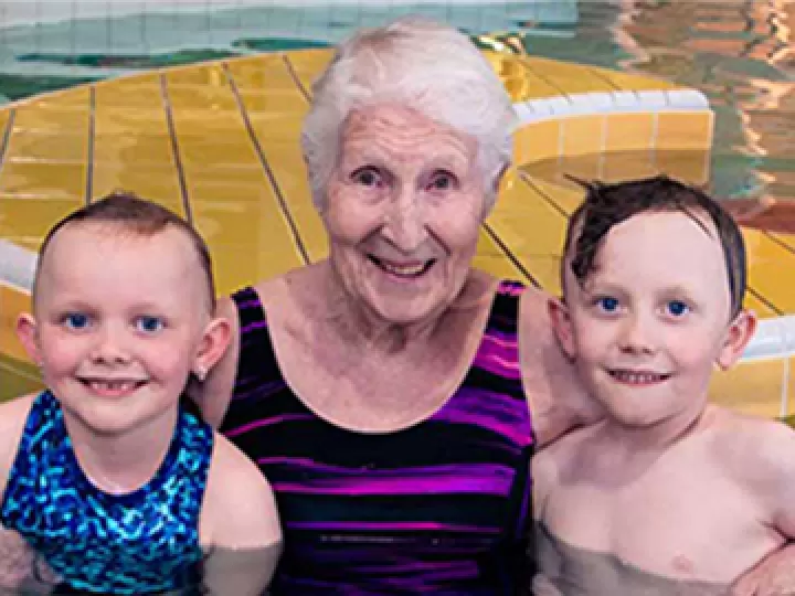 Jill in the pool with two children