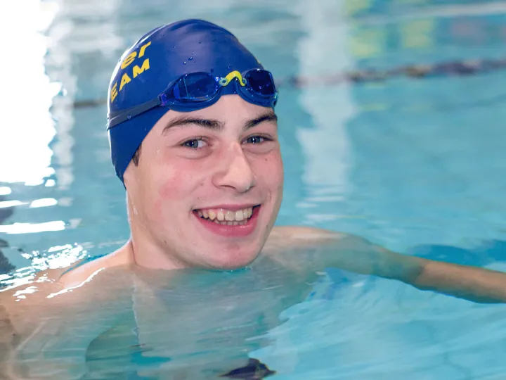 Zachary Bernier smiles up from Kelowna Family Y swimming lane