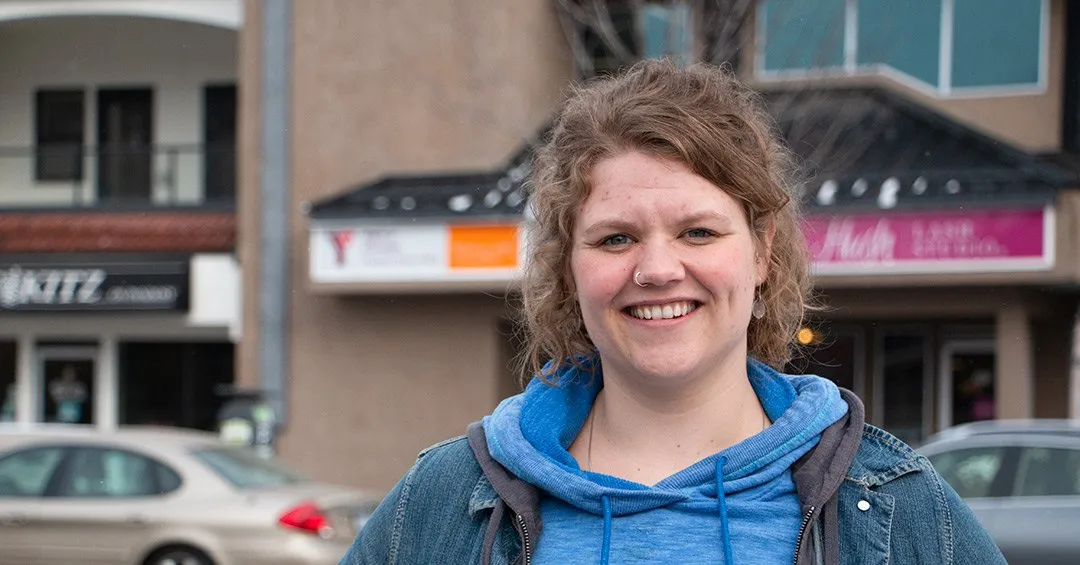 Kiah standing in front of the Pandosy Street YMCA