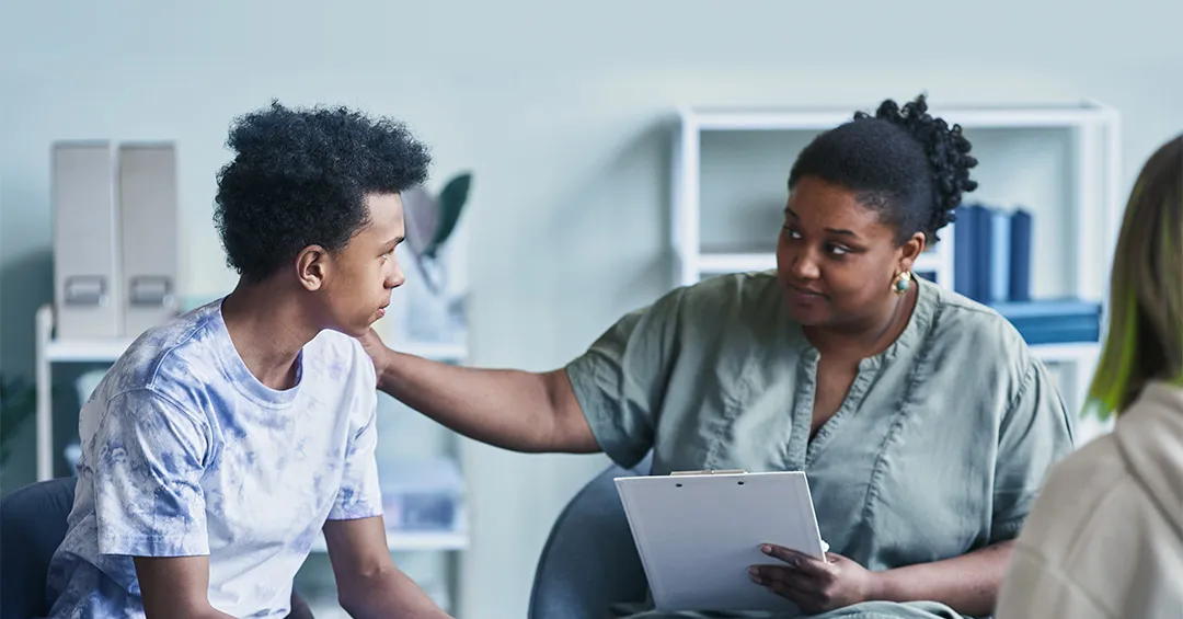 teens getting support from adult program facilitator