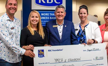 Group from RBC receiving a large check