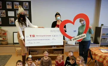3 women holding up a cheque with children