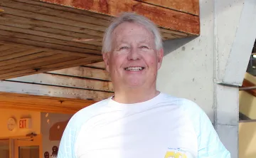Man smiling by a pool
