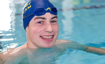 Zachary Bernier smiles up from Kelowna Family Y swimming lane
