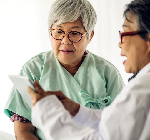 Doctor showing information to senior patient